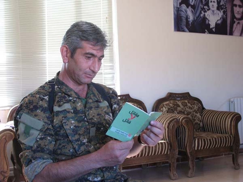 © Geneva Call - Syrian fighter reading a booklet on international humanitarian norms