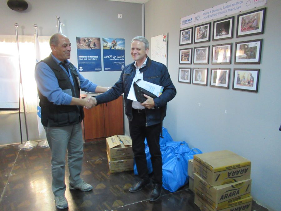 GCSP participants and staff offer gifts for schools at Zaatari Camp